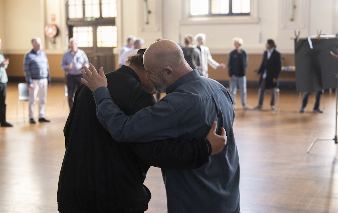 two men patting each others' backs